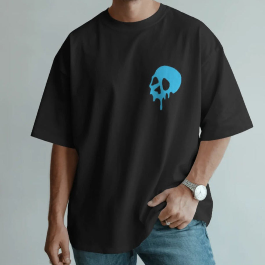 Man wearing a black t-shirt with a blue skull design on a plain background